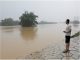 resident looks on as he stands near a flooded river following heavy rainfall in qingyuan guangdong province china april 22 2024 reuters tingshu wang